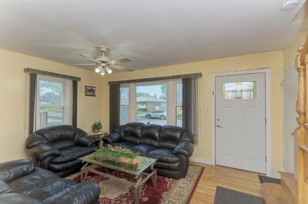 a living room with furniture and wooden floor