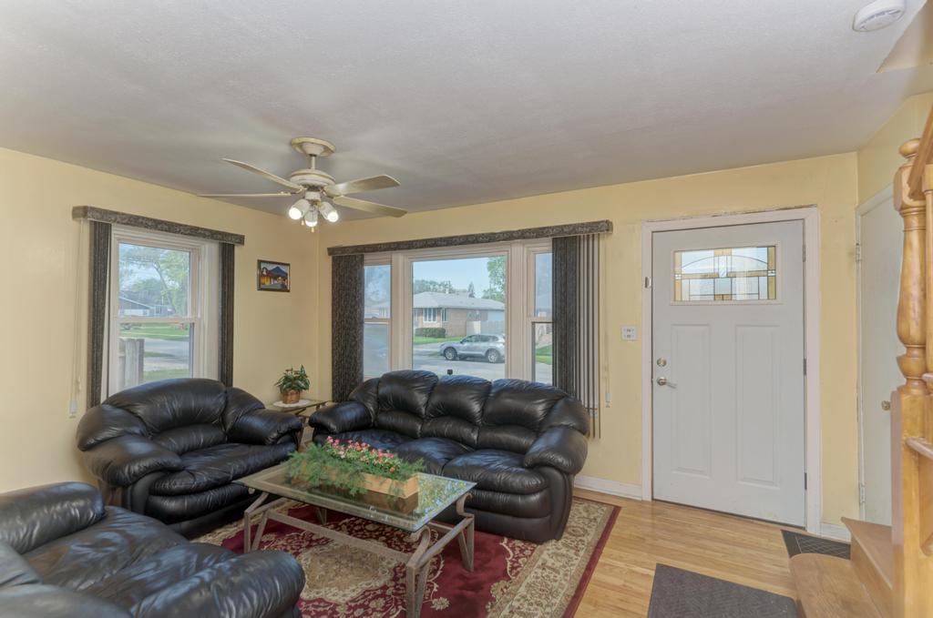 1431 North Hillside Avenue Berkeley, IL 60163 - Photo 3 of 29 a living room with furniture and wooden floor