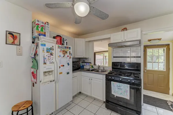 a kitchen with a refrigerator and a stove top oven