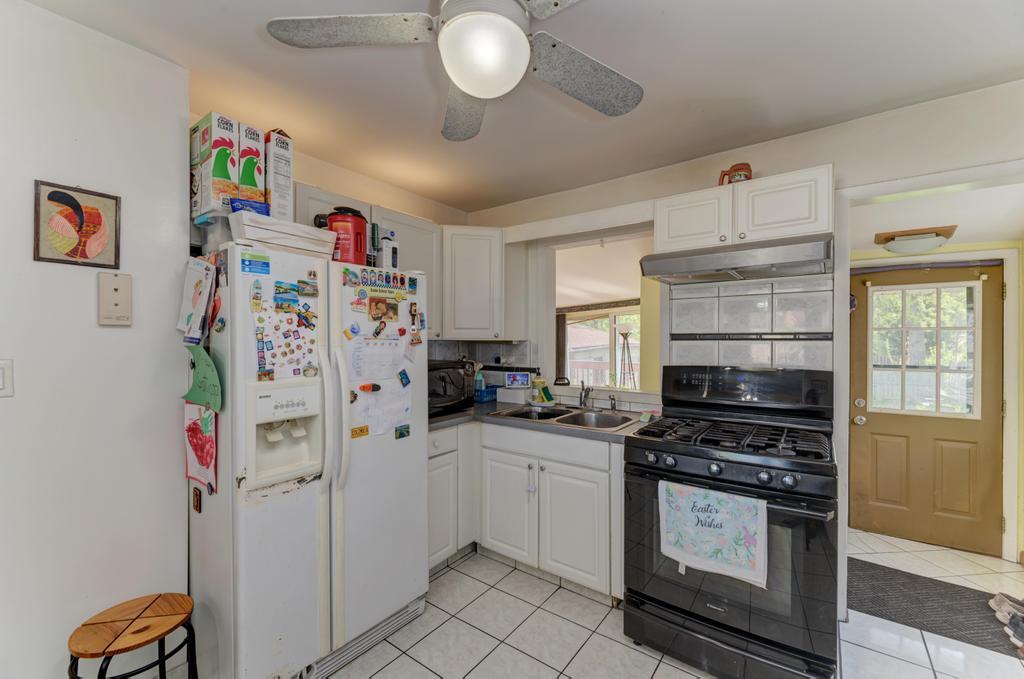 1431 North Hillside Avenue Berkeley, IL 60163 - Photo 8 of 29 a kitchen with a refrigerator and a stove top oven