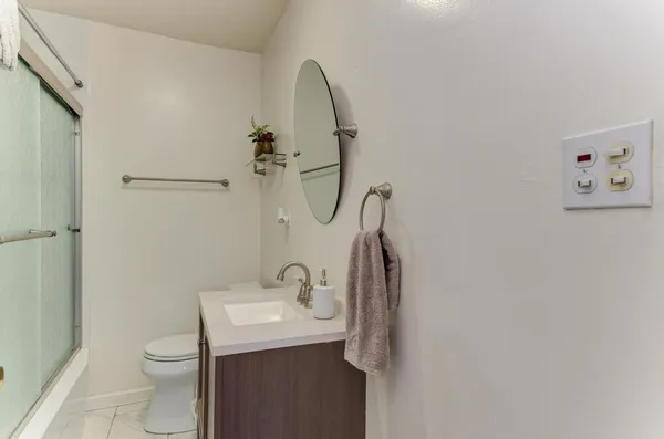 a bathroom with a sink toilet and shower