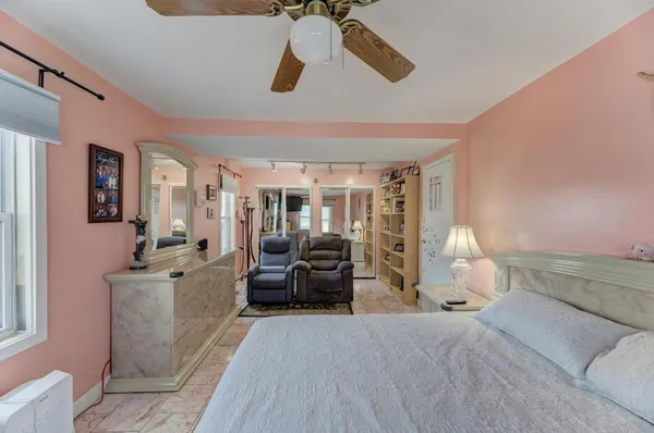 a bedroom with furniture and wooden floor