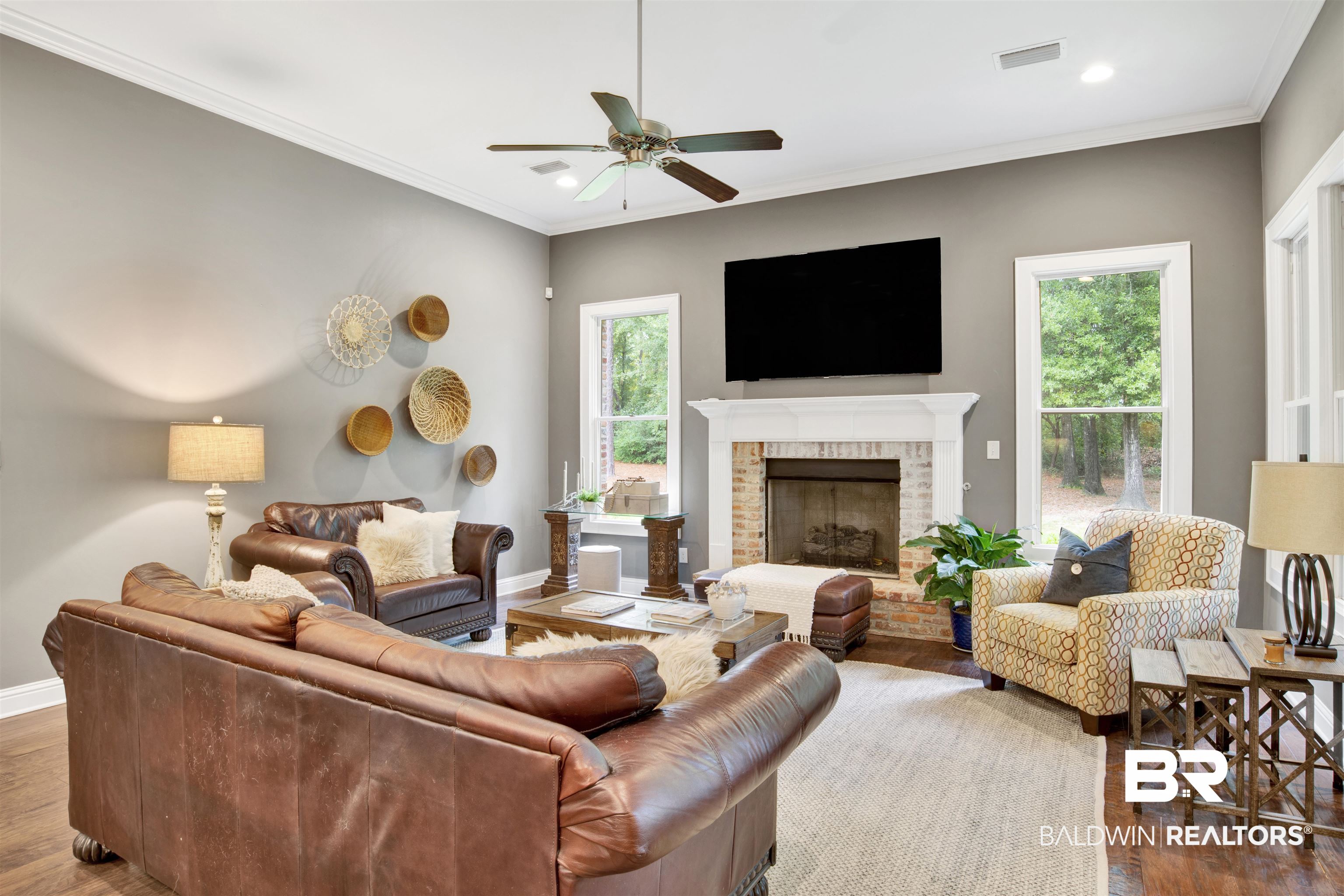 11244 Redfern Road Daphne, AL 36526 - Photo 12 of 50 Living room with ornamental molding, dark hardwood / wood-style flooring, a brick fireplace, and ceiling fan