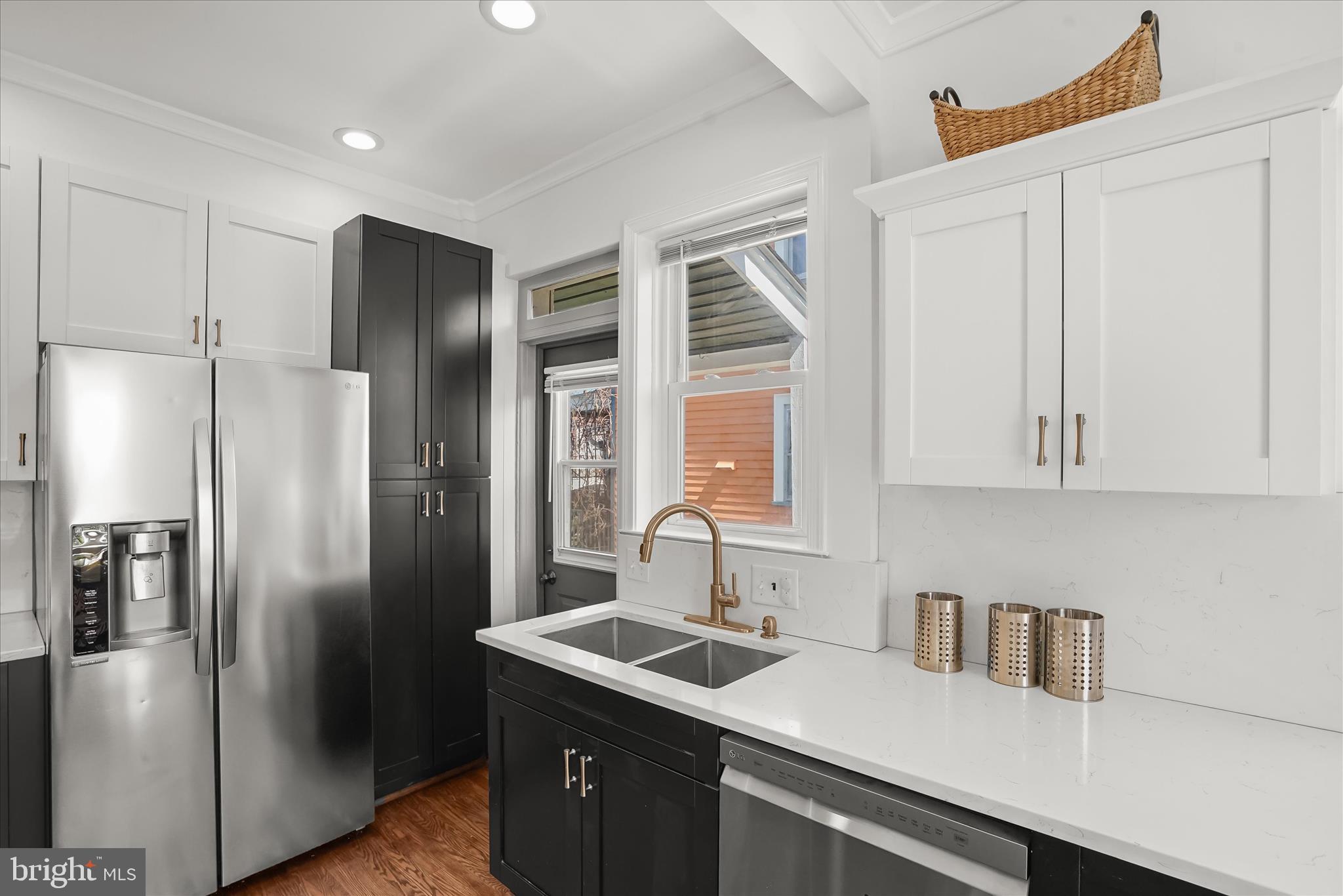 6601 7th Street Northwest Washington, DC 20012 - Photo 13 of 52 a kitchen with stainless steel appliances granite countertop a refrigerator and a sink