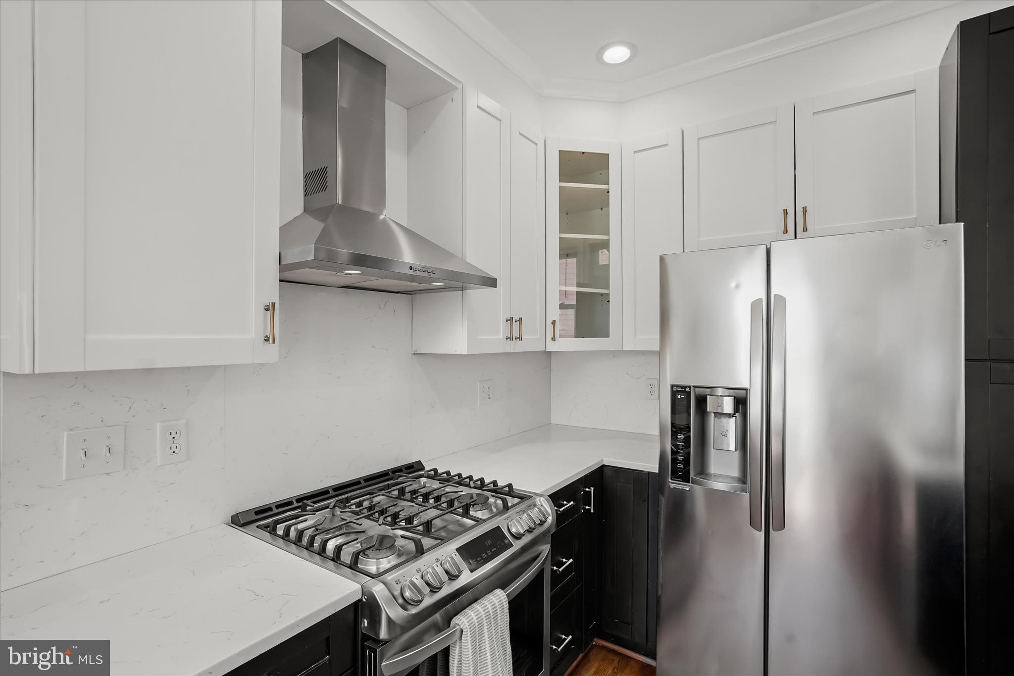 6601 7th Street Northwest Washington, DC 20012 - Photo 14 of 52 a kitchen with stainless steel appliances granite countertop a refrigerator and a stove
