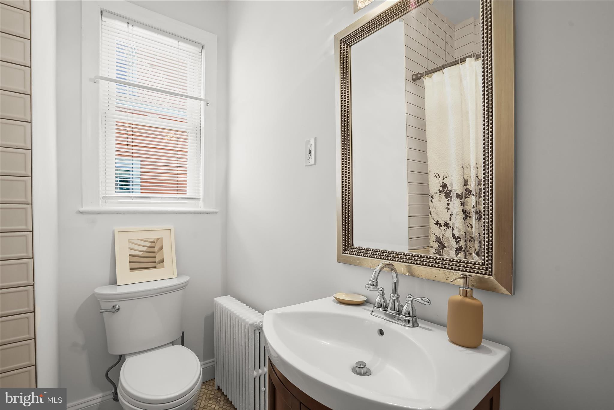 6601 7th Street Northwest Washington, DC 20012 - Photo 19 of 52 a bathroom with a toilet sink and mirror