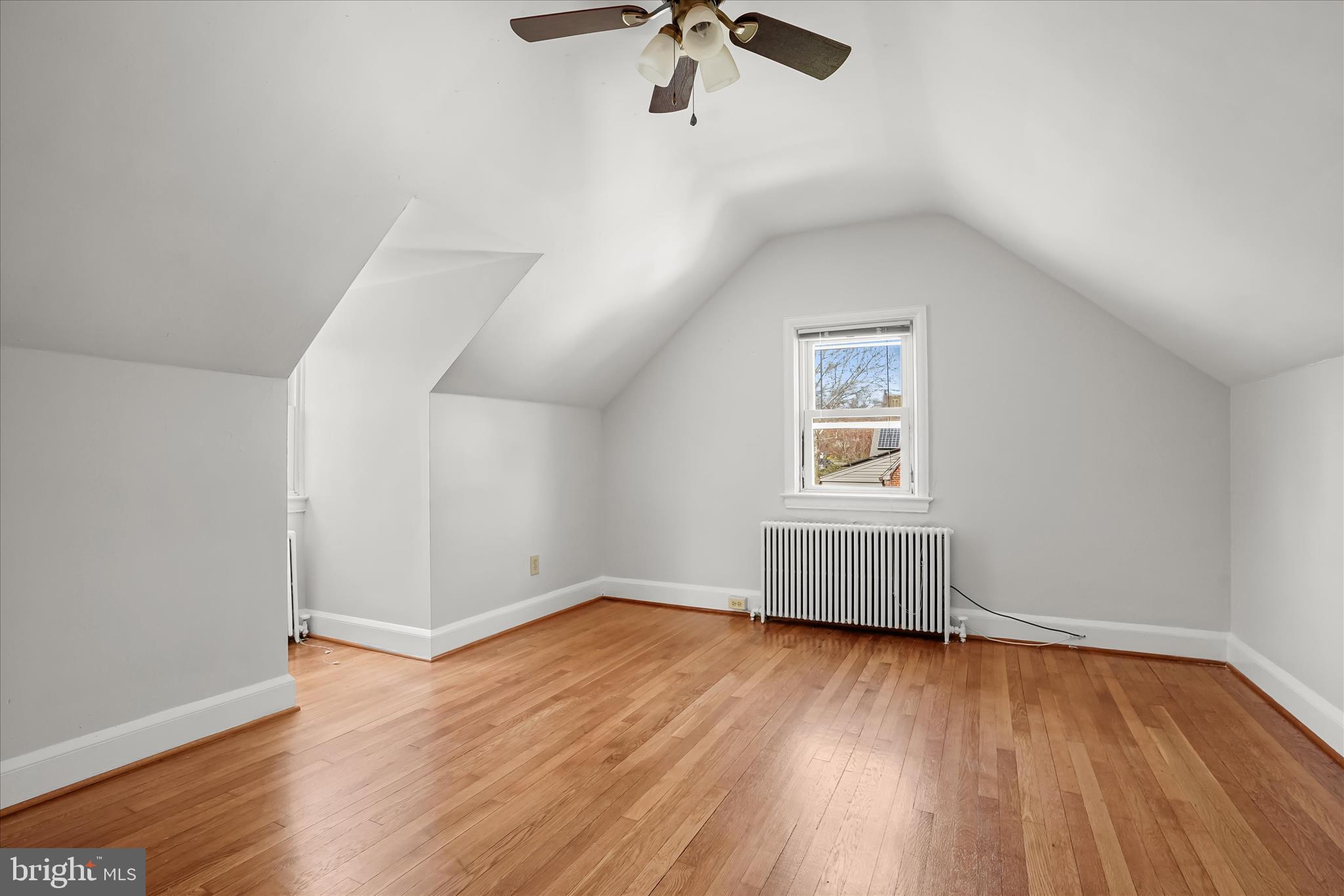 6601 7th Street Northwest Washington, DC 20012 - Photo 26 of 52 an empty room with wooden floor chandelier fan and windows