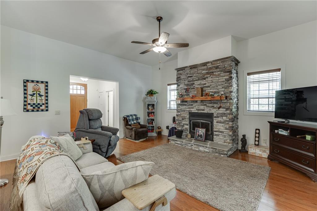 7660 Fern Lane Lula, GA 30554 - Photo 11 of 50 a living room with furniture a fireplace and a flat screen tv