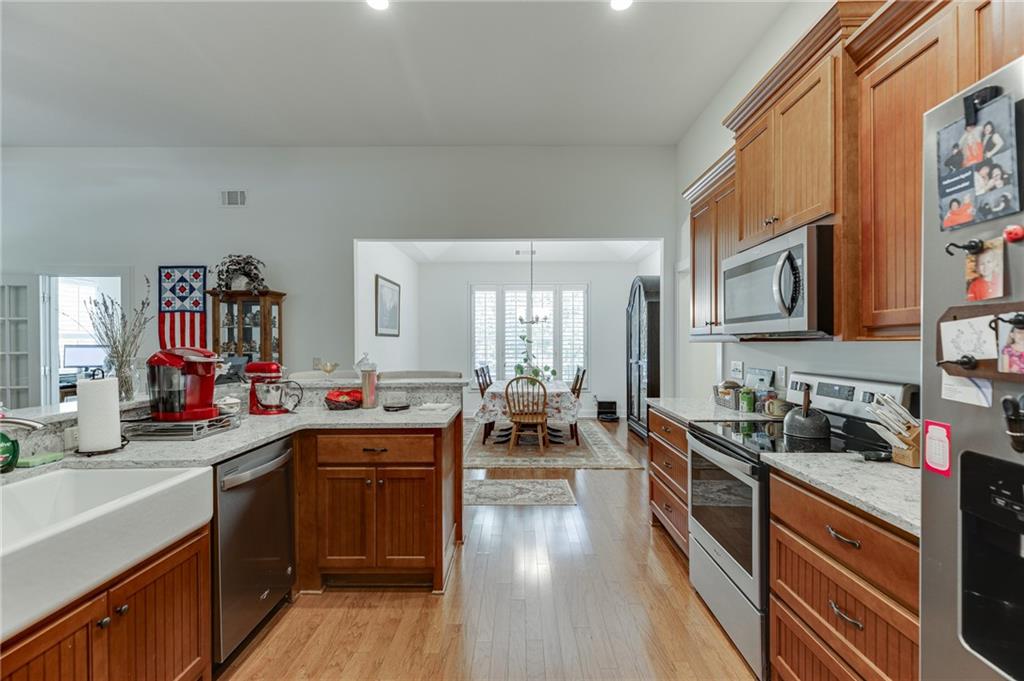 7660 Fern Lane Lula, GA 30554 - Photo 12 of 50 a kitchen with lots of counter top space a sink and appliances