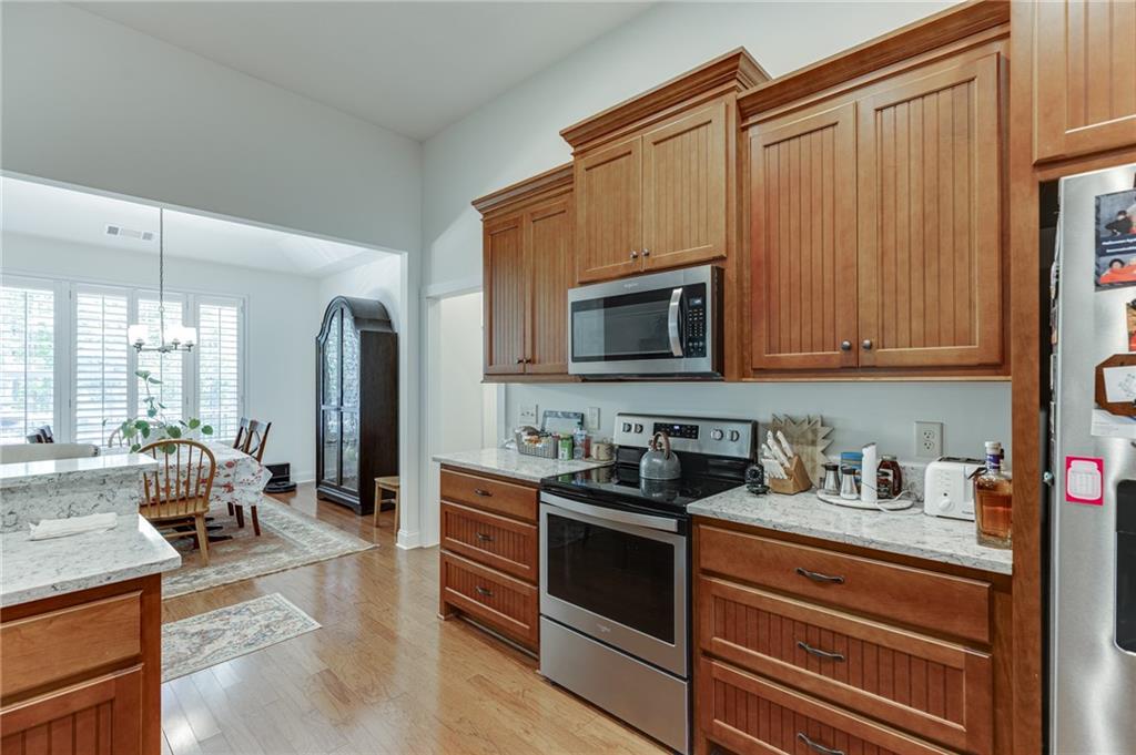 7660 Fern Lane Lula, GA 30554 - Photo 13 of 50 a kitchen with stainless steel appliances granite countertop a stove a sink and a microwave