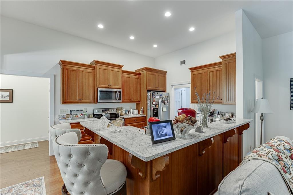 7660 Fern Lane Lula, GA 30554 - Photo 17 of 50 a kitchen with a stove a sink and a refrigerator