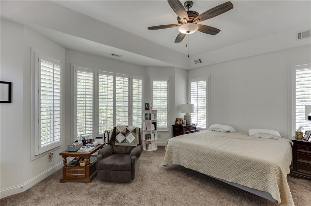7660 Fern Lane Lula, GA 30554 - Photo 21 of 50 a spacious bedroom with a bed and a large window