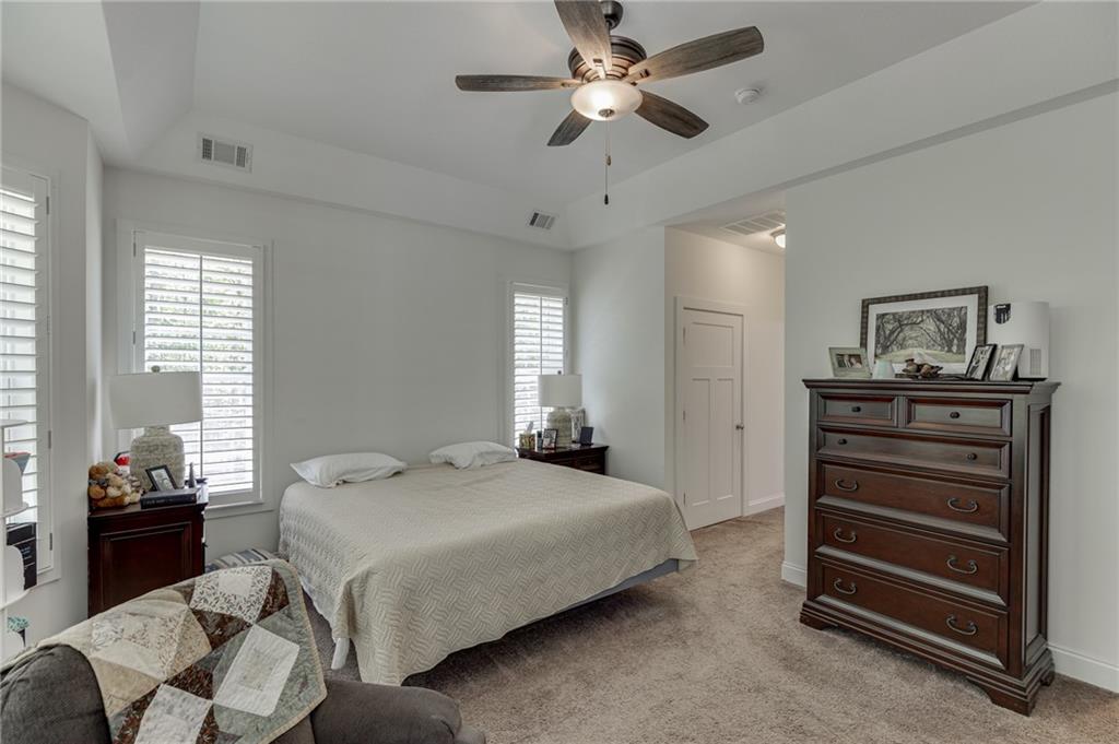 7660 Fern Lane Lula, GA 30554 - Photo 22 of 50 a bedroom with a bed and a chandelier