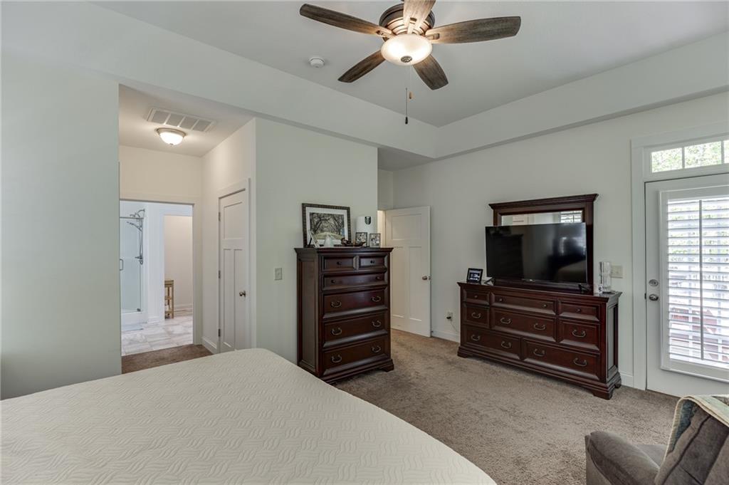 7660 Fern Lane Lula, GA 30554 - Photo 23 of 50 a bedroom with a bed and a flat screen tv