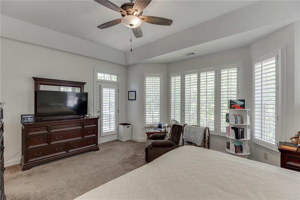 7660 Fern Lane Lula, GA 30554 - Photo 24 of 50 a bedroom with furniture and a flat screen tv