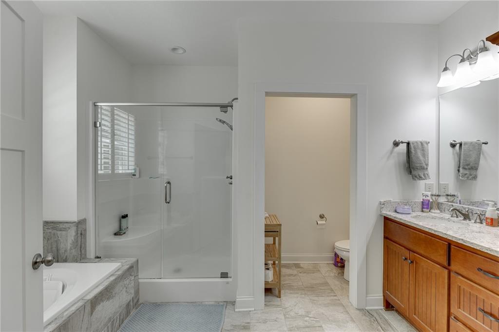 7660 Fern Lane Lula, GA 30554 - Photo 25 of 50 a bathroom with a tub sink toilet and vanity