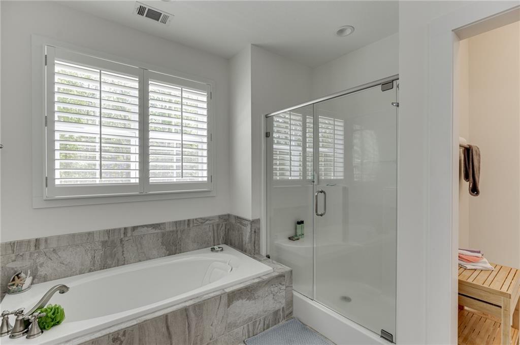 7660 Fern Lane Lula, GA 30554 - Photo 27 of 50 a bathroom with a bathtub and shower