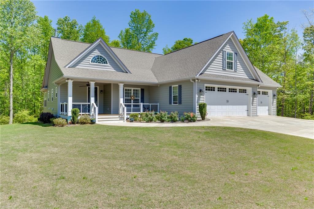 7660 Fern Lane Lula, GA 30554 - Photo 3 of 50 a front view of a house with garden