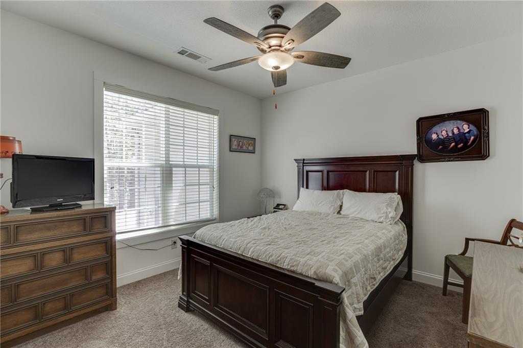 7660 Fern Lane Lula, GA 30554 - Photo 31 of 50 a bedroom with a bed and a flat screen tv