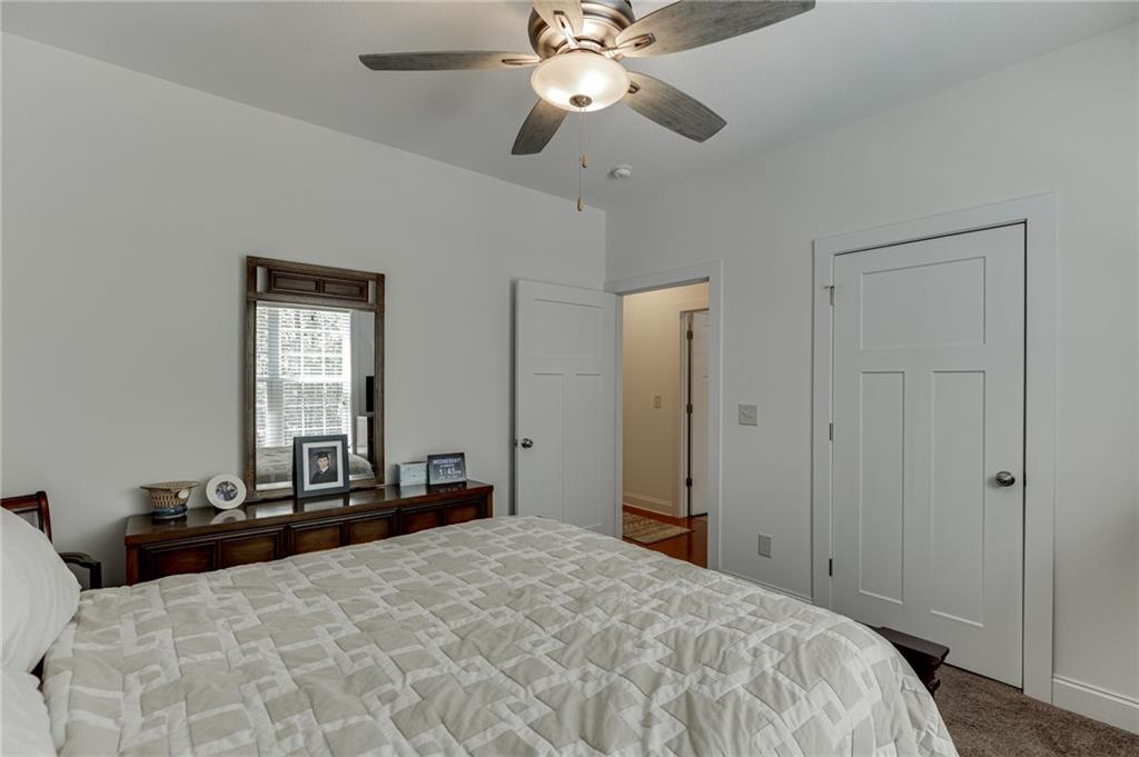 7660 Fern Lane Lula, GA 30554 - Photo 32 of 50 a bedroom with a bed and a chandelier