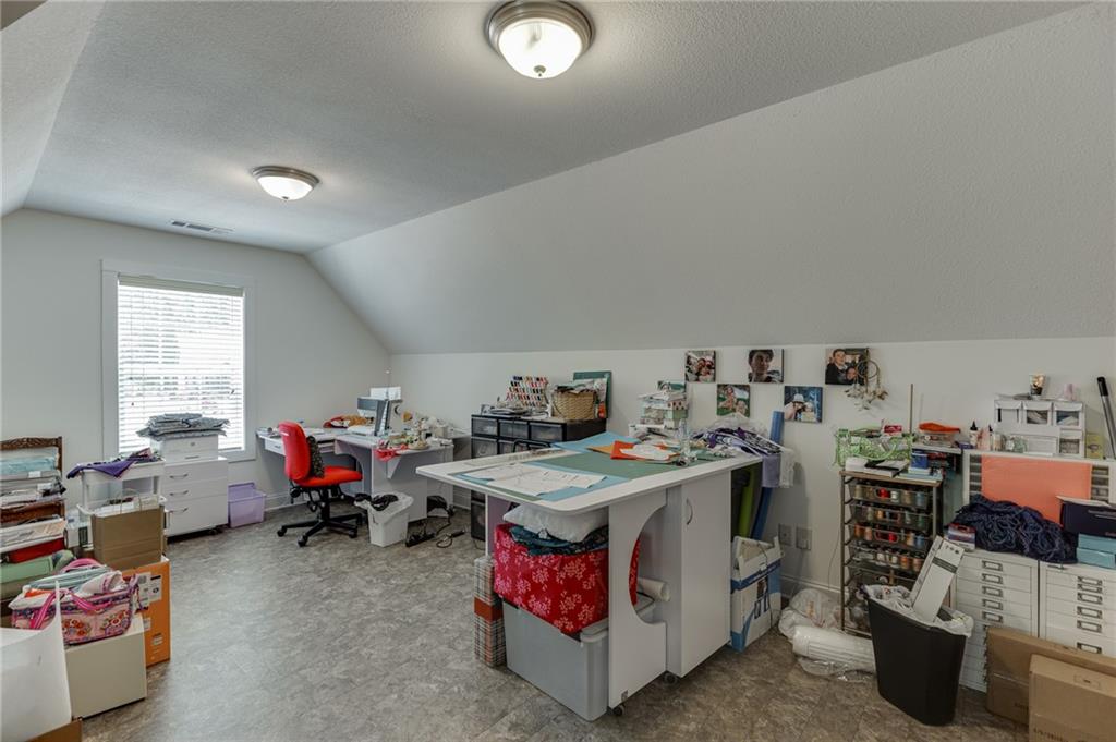 7660 Fern Lane Lula, GA 30554 - Photo 34 of 50 a bed room with a bed and a couch