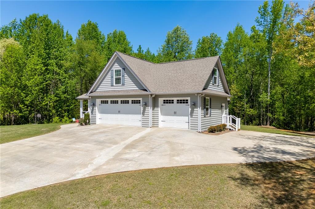7660 Fern Lane Lula, GA 30554 - Photo 45 of 50 a front view of a house with a garden