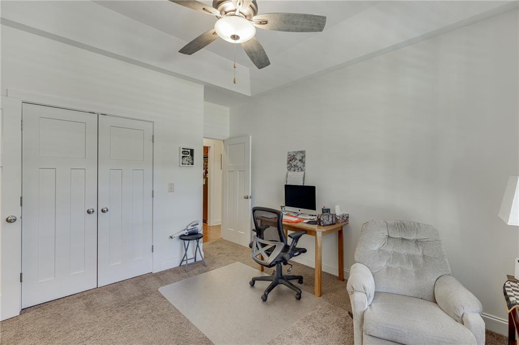7660 Fern Lane Lula, GA 30554 - Photo 8 of 50 a view of a workspace with furniture and a ceiling fan