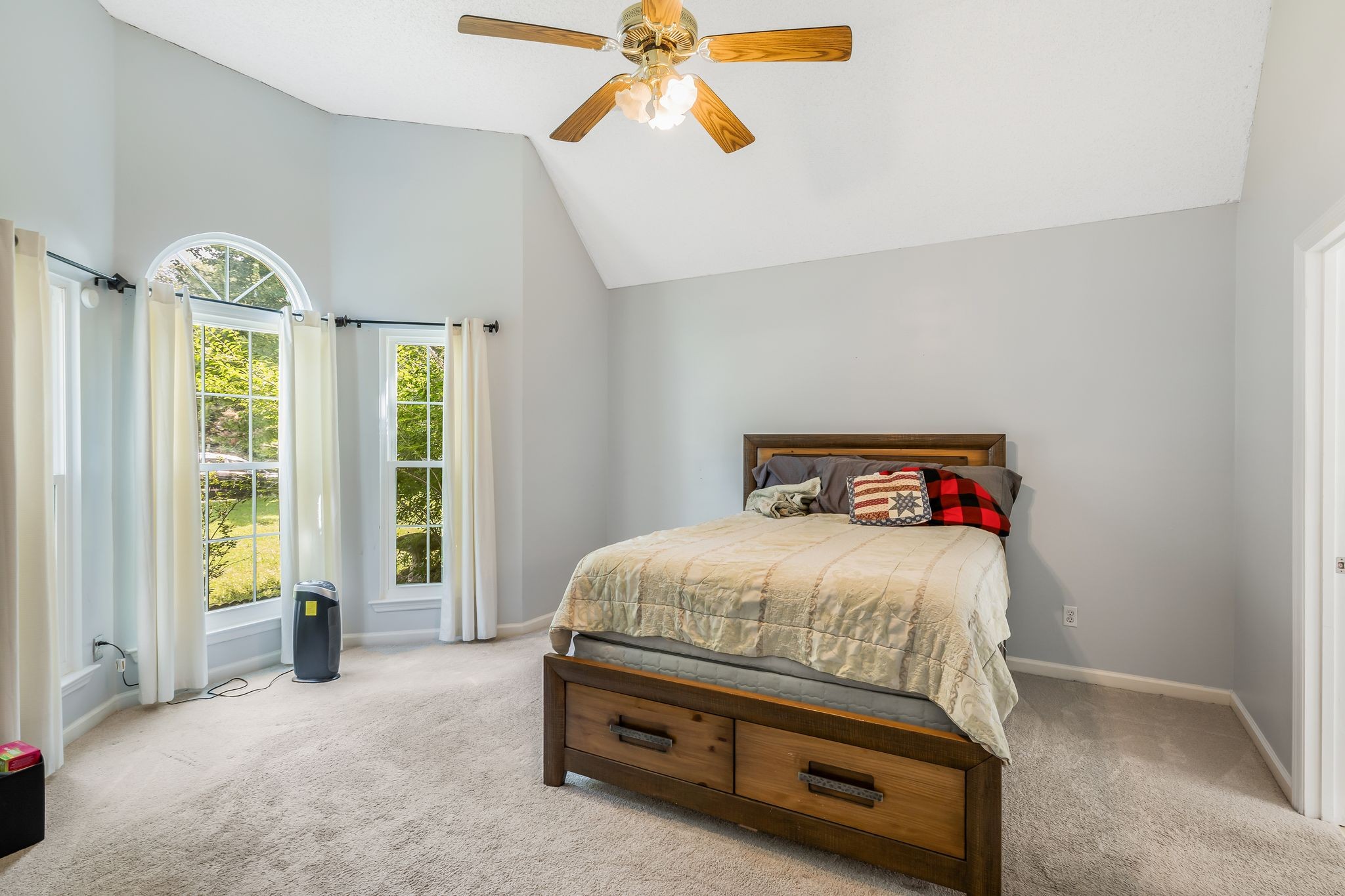 2117 Spring Hill Circle Spring Hill, TN 37174 - Photo 16 of 32 a bedroom with a bed and a chandelier