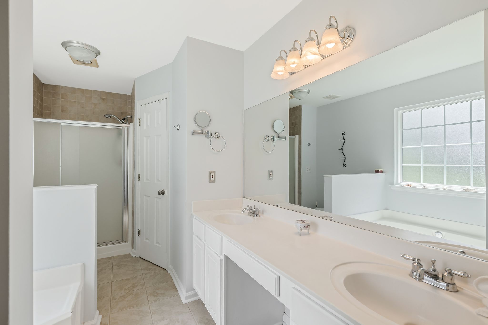 2117 Spring Hill Circle Spring Hill, TN 37174 - Photo 17 of 32 a bathroom with a double vanity sink and a mirror