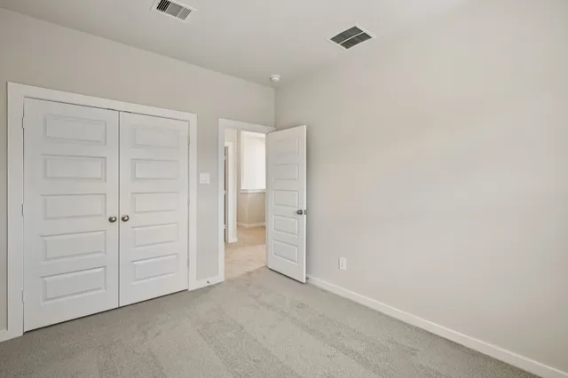 an empty room with closet area