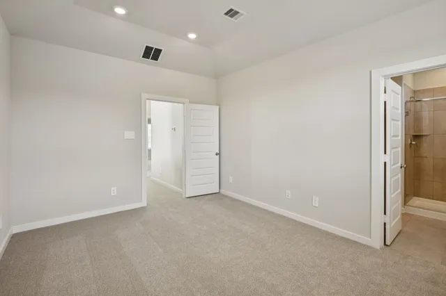 an empty room with closet and a bathroom
