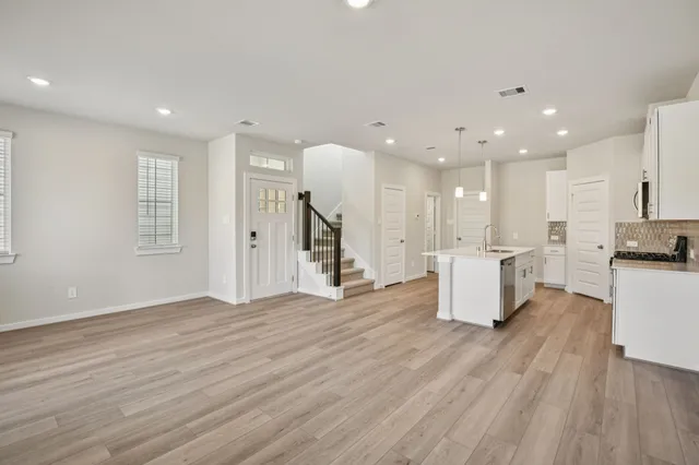 a view of kitchen with cabinets and wooden floor