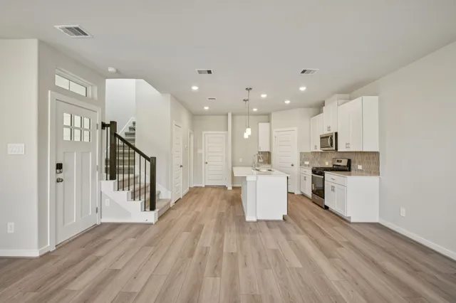 a view of kitchen with cabinets and wooden floor
