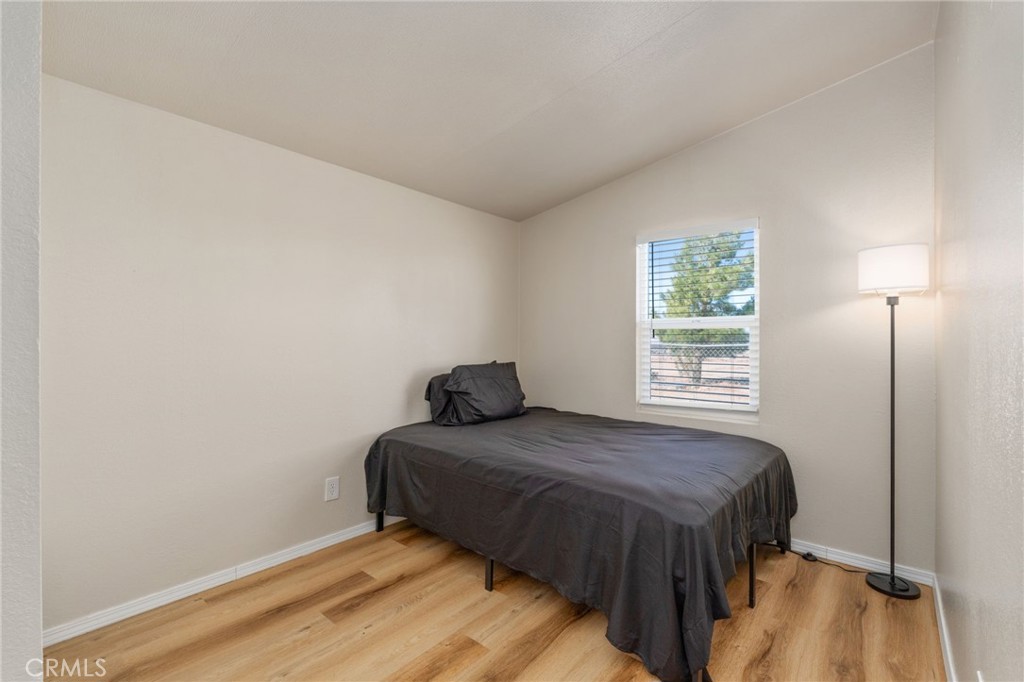 11524 Paramount Road Phelan, CA 92371 - Photo 15 of 34 a bedroom with a bed and a window