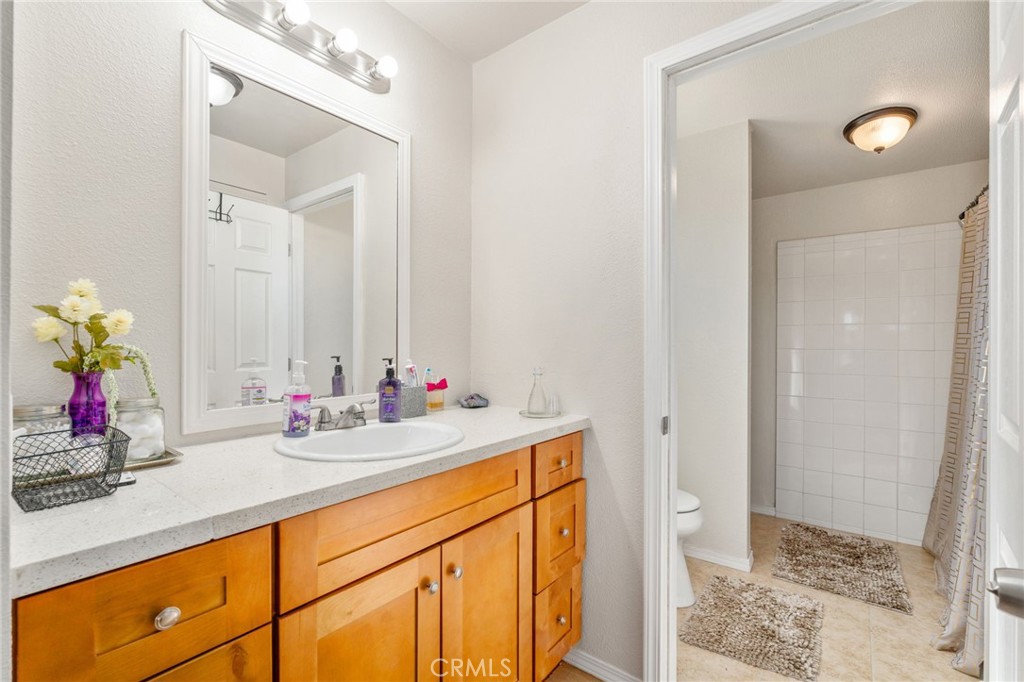 11524 Paramount Road Phelan, CA 92371 - Photo 22 of 34 a bathroom with a sink and a mirror
