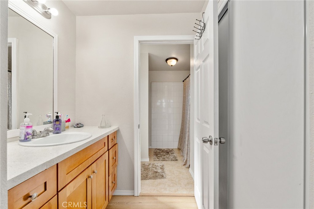 11524 Paramount Road Phelan, CA 92371 - Photo 23 of 34 a bathroom with a sink vanity and a mirror