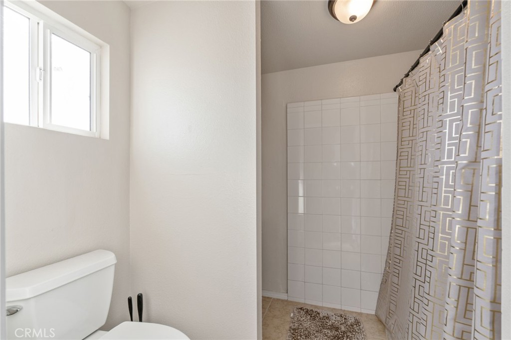 11524 Paramount Road Phelan, CA 92371 - Photo 24 of 34 a bathroom with a toilet and a shower