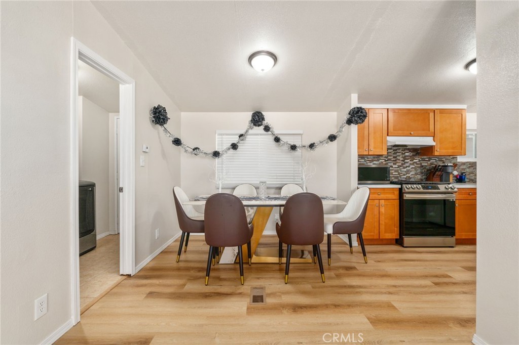 11524 Paramount Road Phelan, CA 92371 - Photo 10 of 34 a view of a dining room with furniture and wooden floor