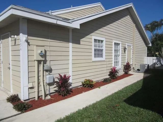 a kitchen with a sink cabinets and a window