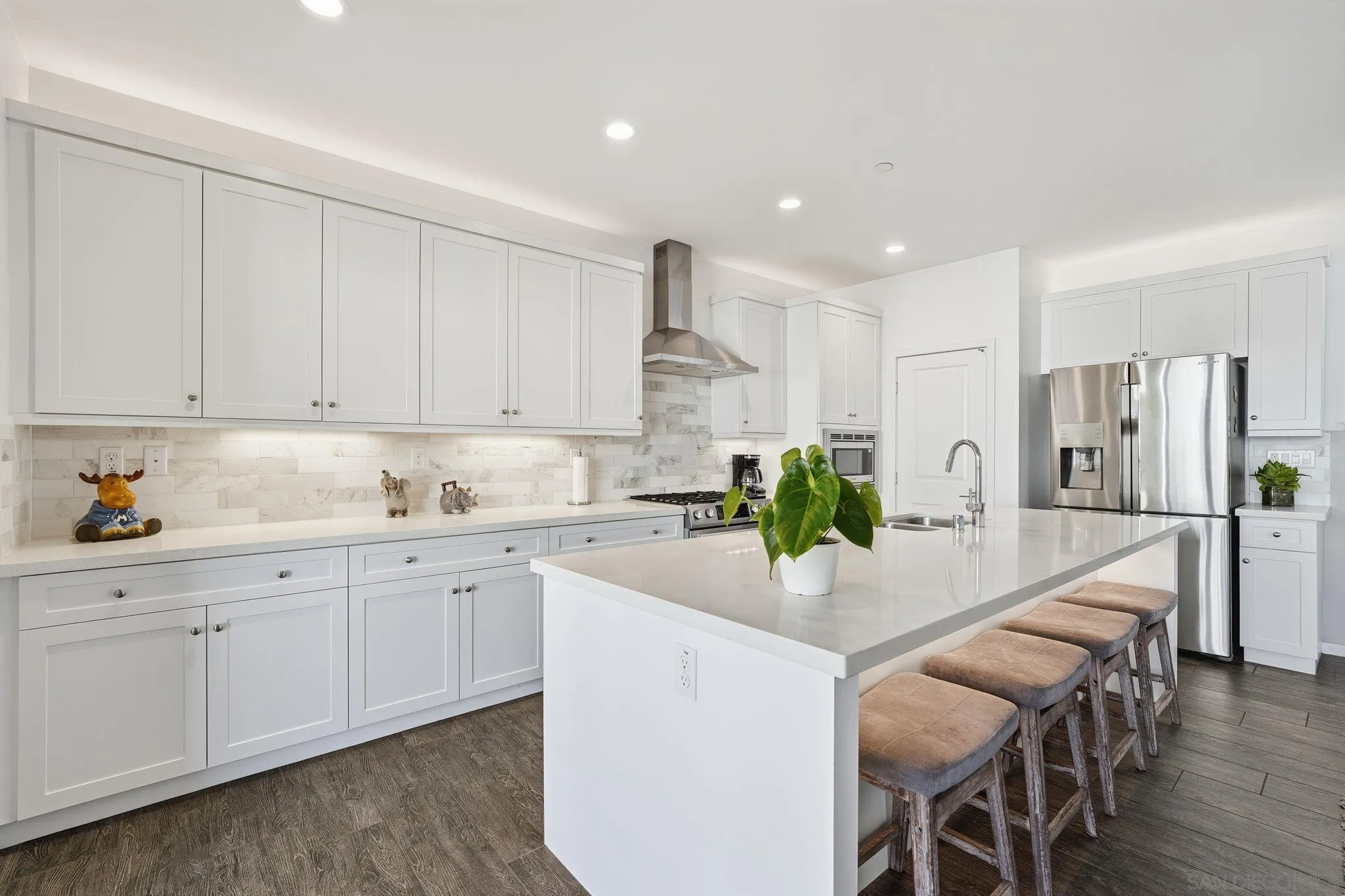 8337 Summit Way San Diego, CA 92108 - Photo 24 of 61 a kitchen with white cabinets and wooden floor