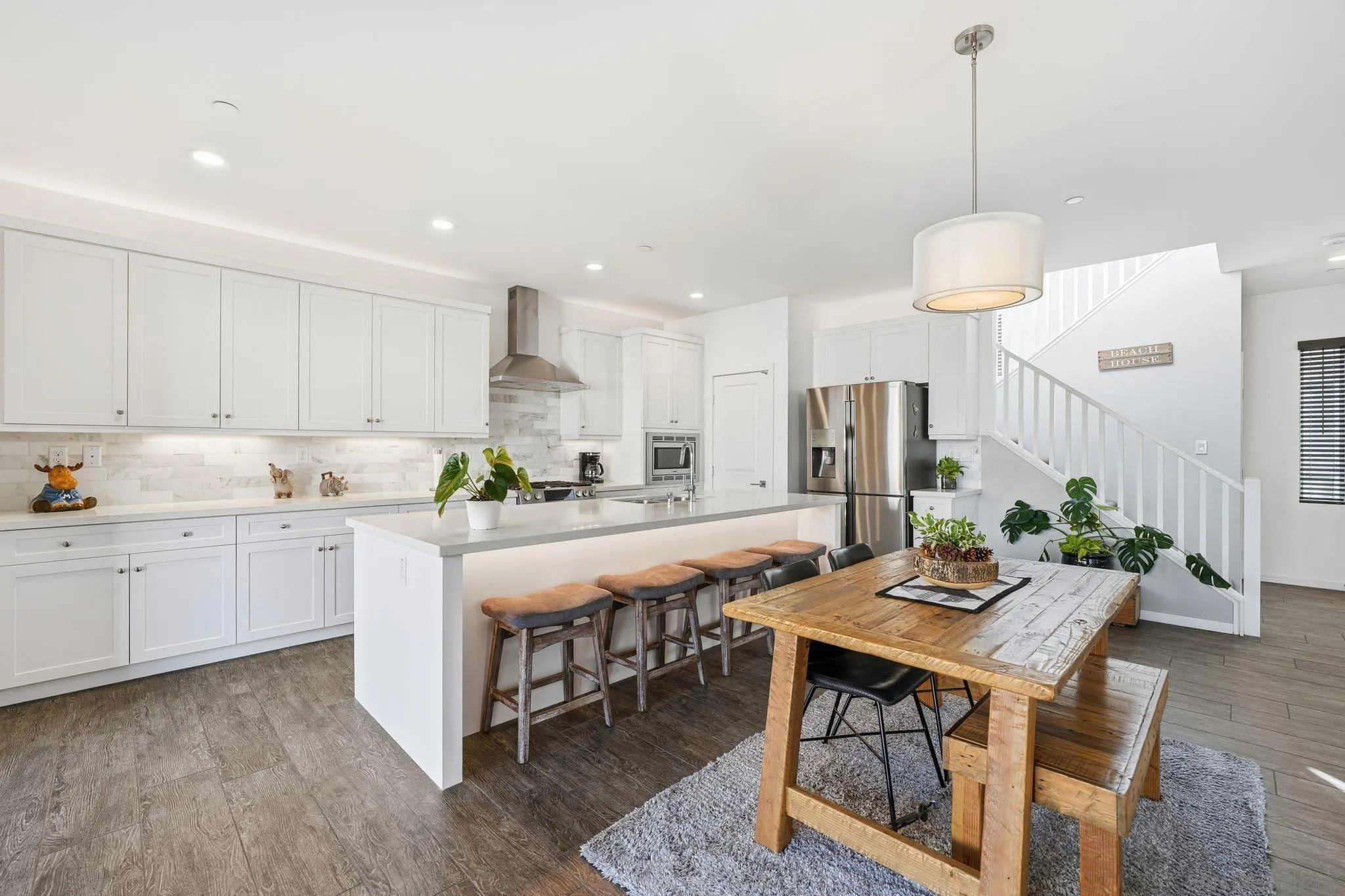 8337 Summit Way San Diego, CA 92108 - Photo 46 of 61 a kitchen with stainless steel appliances granite countertop a stove top oven a refrigerator a sink and white cabinets with wooden floor