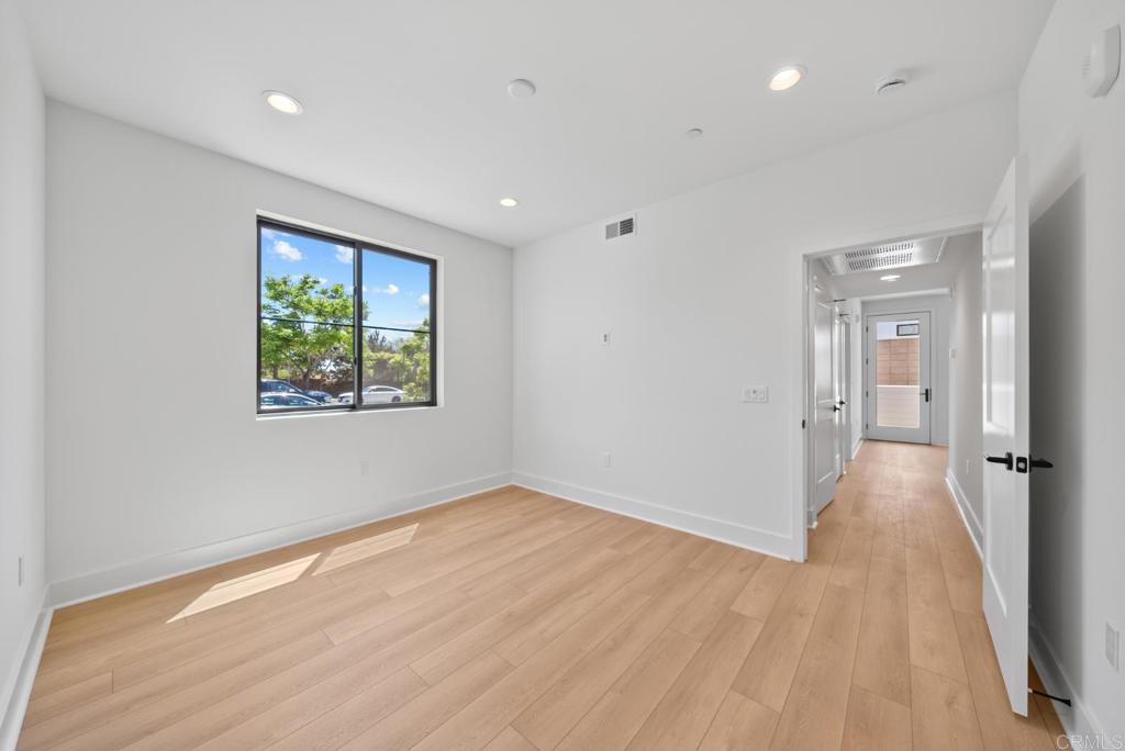 1101 Catania, Unit 104 Encinitas, CA 92024 - Photo 13 of 41 wooden floor in an empty room with a window