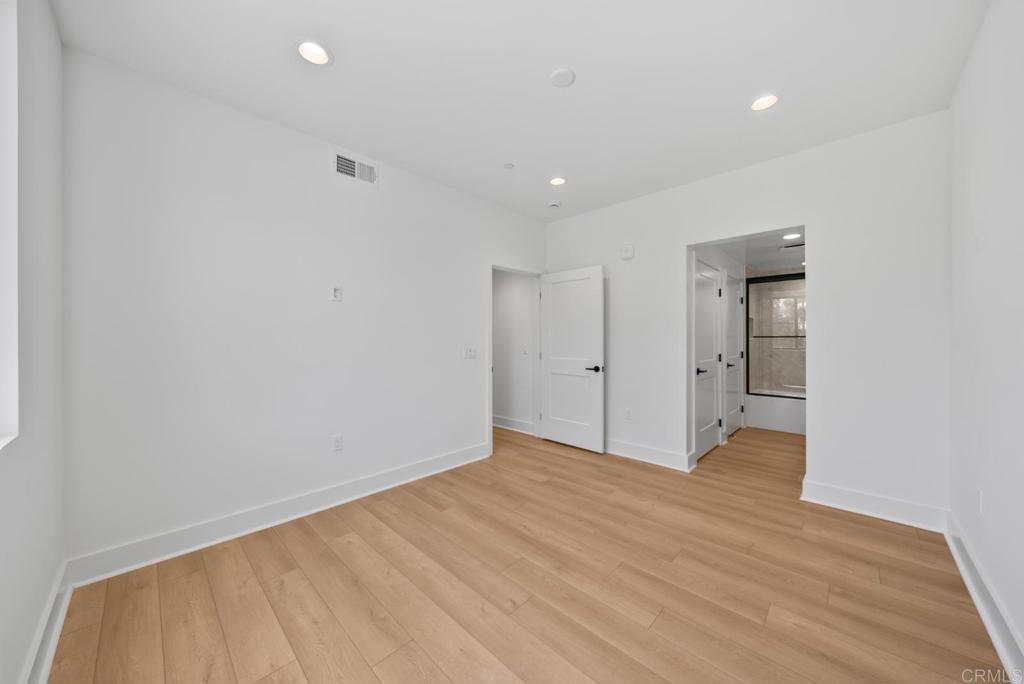 1101 Catania, Unit 104 Encinitas, CA 92024 - Photo 14 of 41 a view of an empty room with wooden floor and closet