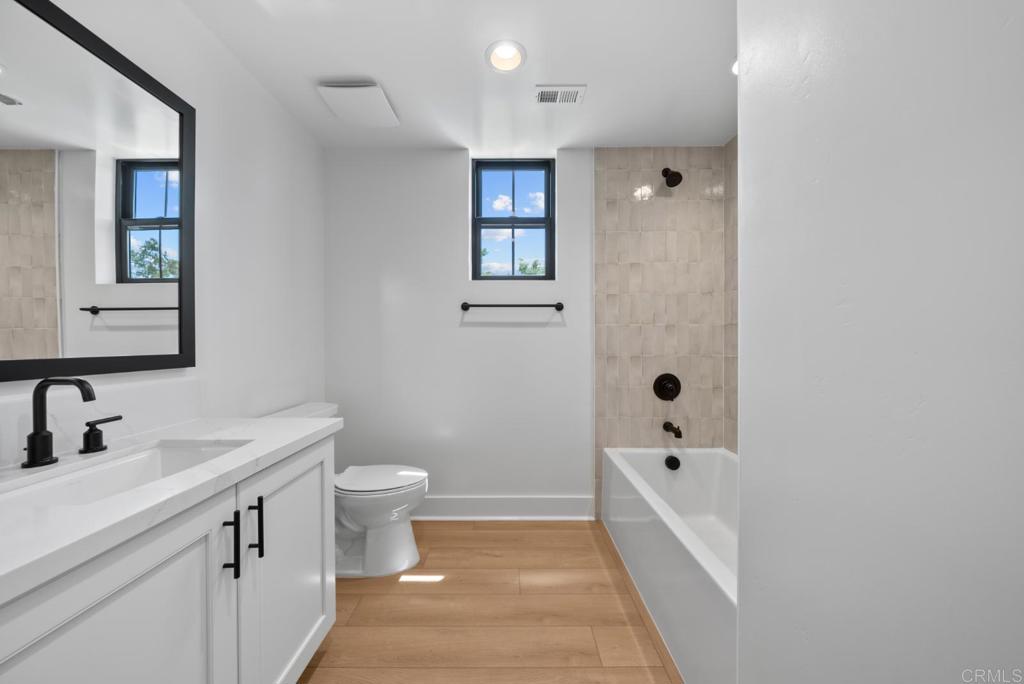 1101 Catania, Unit 104 Encinitas, CA 92024 - Photo 18 of 41 a bathroom with a sink a toilet and shower