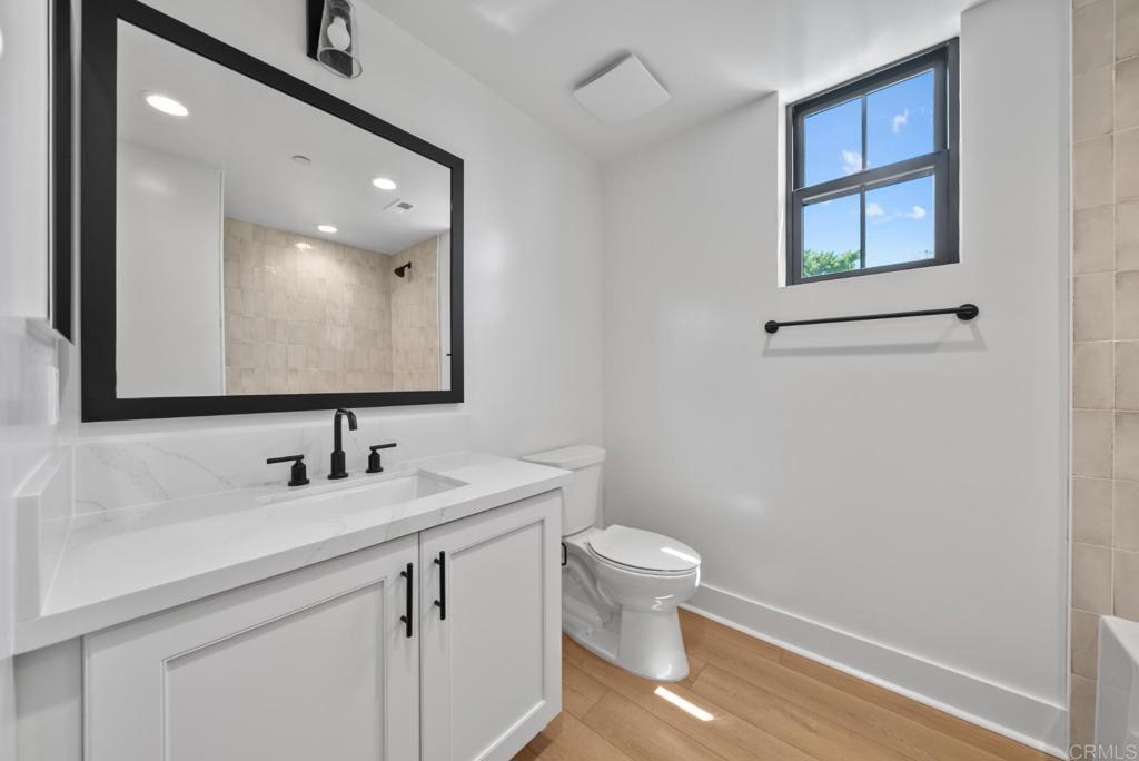 1101 Catania, Unit 104 Encinitas, CA 92024 - Photo 19 of 41 a bathroom with a toilet sink and mirror