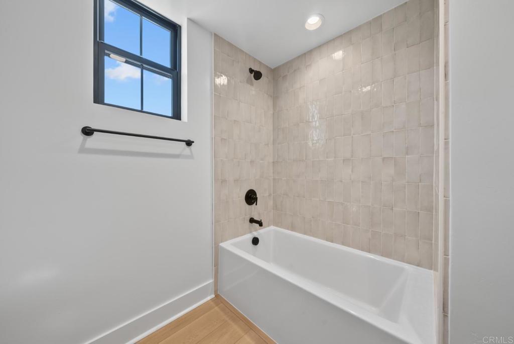 1101 Catania, Unit 104 Encinitas, CA 92024 - Photo 20 of 41 a bathroom with a bathtub and shower