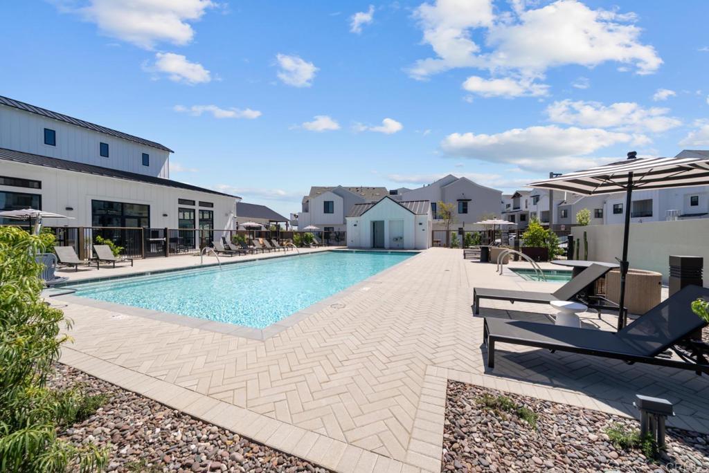 1101 Catania, Unit 104 Encinitas, CA 92024 - Photo 2 of 41 a view of a swimming pool with a patio and couches chairs