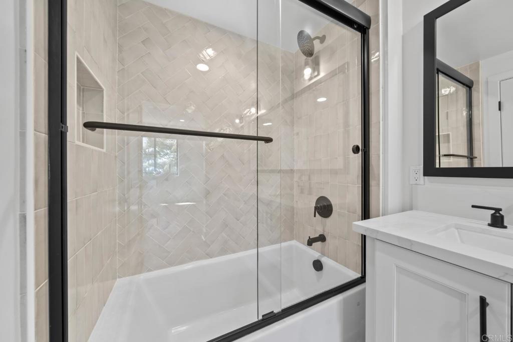 1101 Catania, Unit 104 Encinitas, CA 92024 - Photo 23 of 41 a bathroom with a sink a mirror and a bathtub
