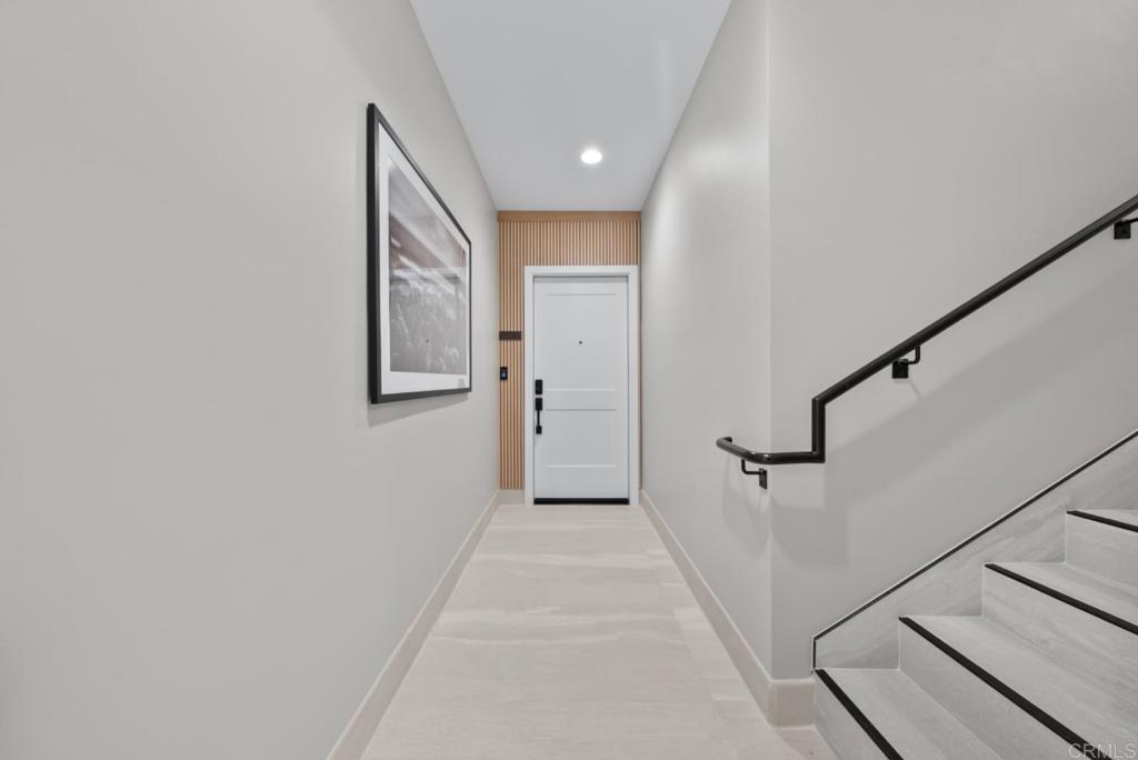 1101 Catania, Unit 104 Encinitas, CA 92024 - Photo 27 of 41 a view of a hallway with wooden floor and staircase