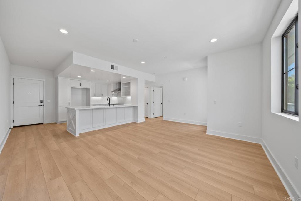 1101 Catania, Unit 104 Encinitas, CA 92024 - Photo 7 of 41 a view of an empty room with kitchen and window